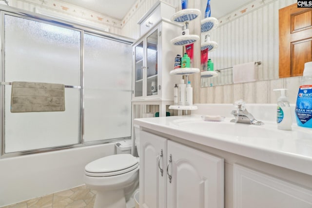 full bathroom with tile patterned flooring, enclosed tub / shower combo, vanity, and toilet