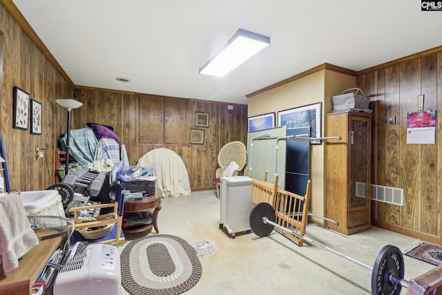 interior space featuring wooden walls, visible vents, carpet flooring, and ornamental molding