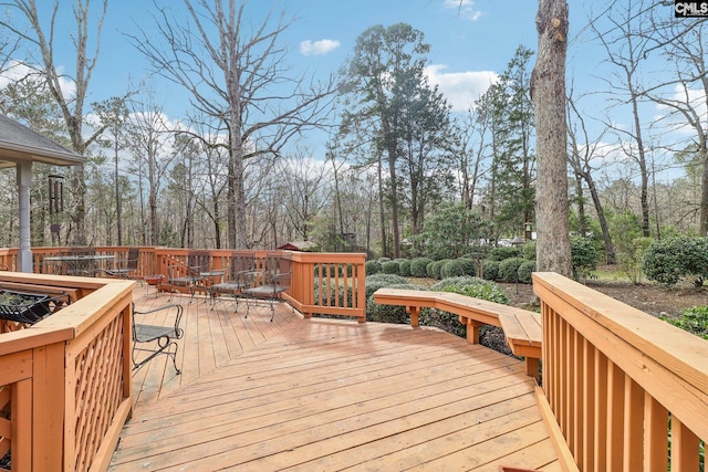 wooden terrace featuring outdoor dining space