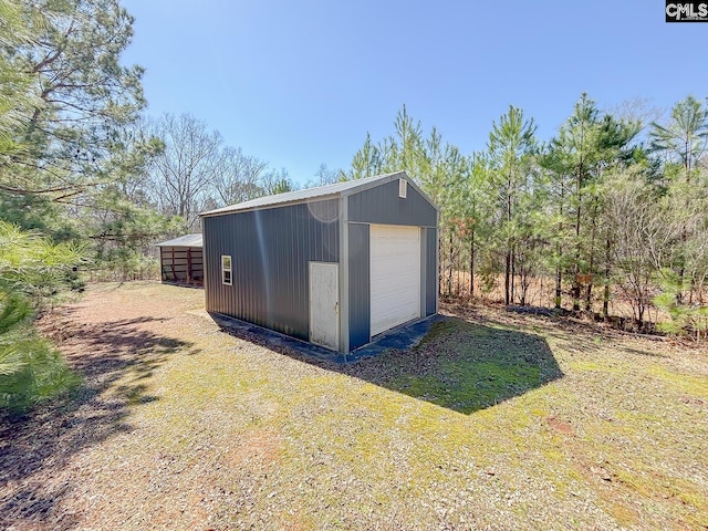 view of outbuilding with an outbuilding and driveway