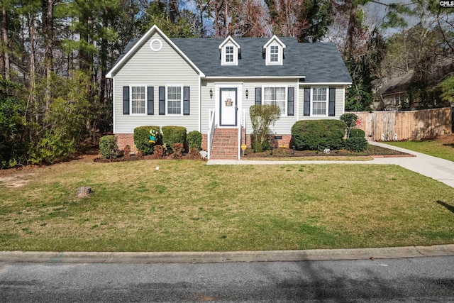 new england style home with a front lawn, crawl space, and fence