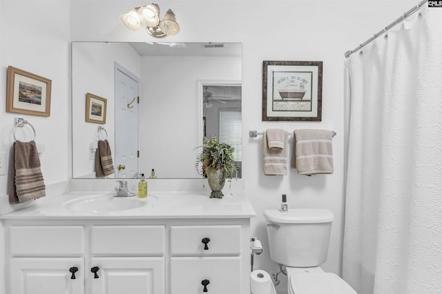 full bathroom with toilet, visible vents, and vanity