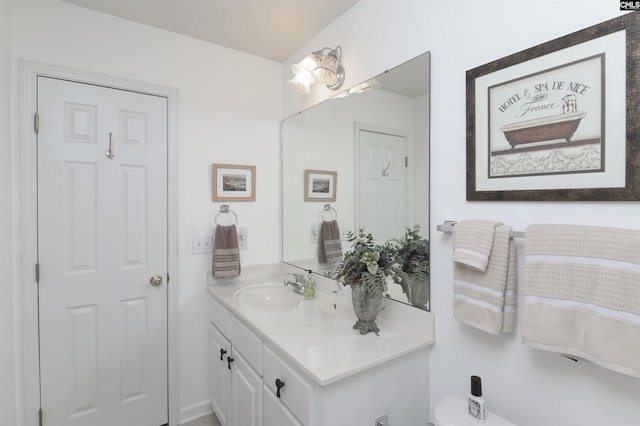 bathroom featuring toilet and vanity