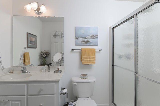 bathroom with toilet, a shower stall, and vanity