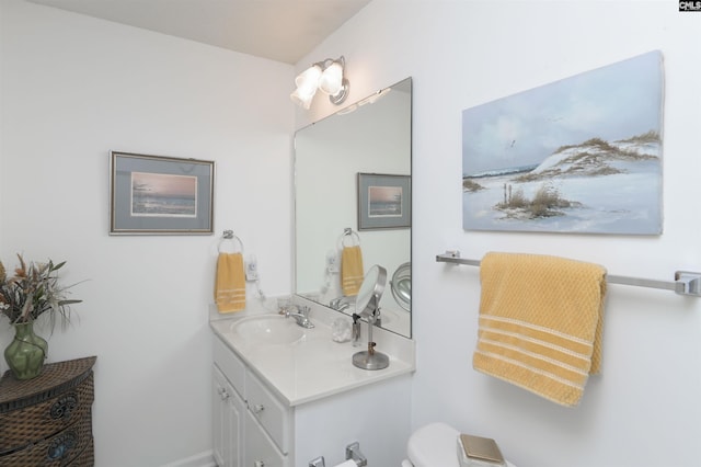 bathroom with toilet and vanity