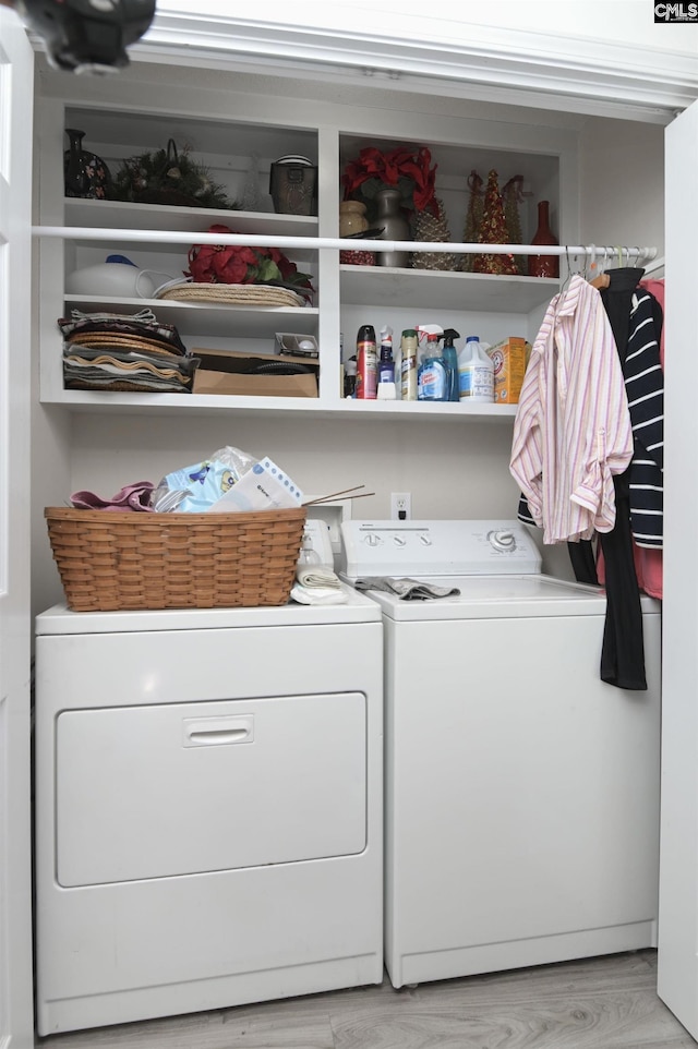 washroom featuring laundry area, independent washer and dryer, and light wood-style flooring