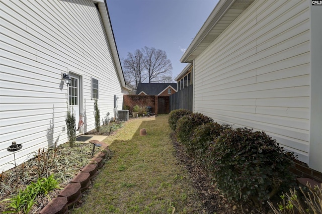 view of yard featuring cooling unit and fence