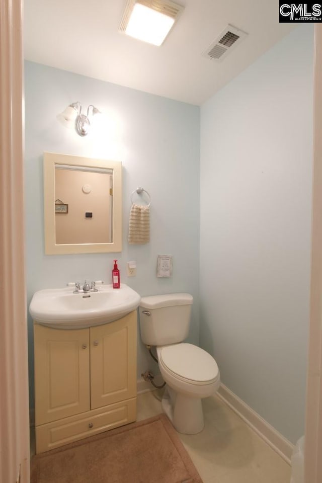 bathroom with visible vents, toilet, vanity, baseboards, and tile patterned floors