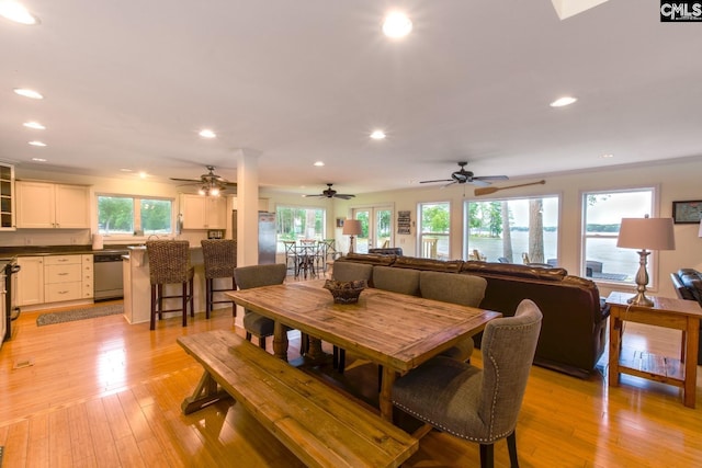 dining area with light wood finished floors and recessed lighting