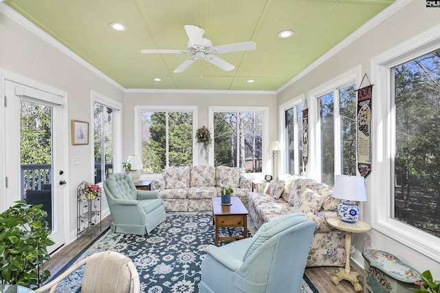 sunroom featuring ceiling fan