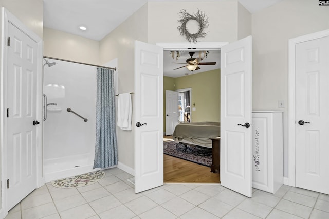 full bath with ensuite bathroom, curtained shower, tile patterned flooring, and a ceiling fan