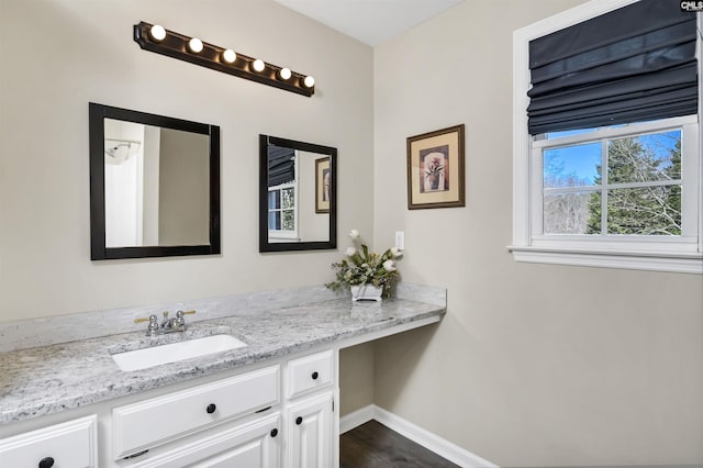 bathroom with baseboards and vanity