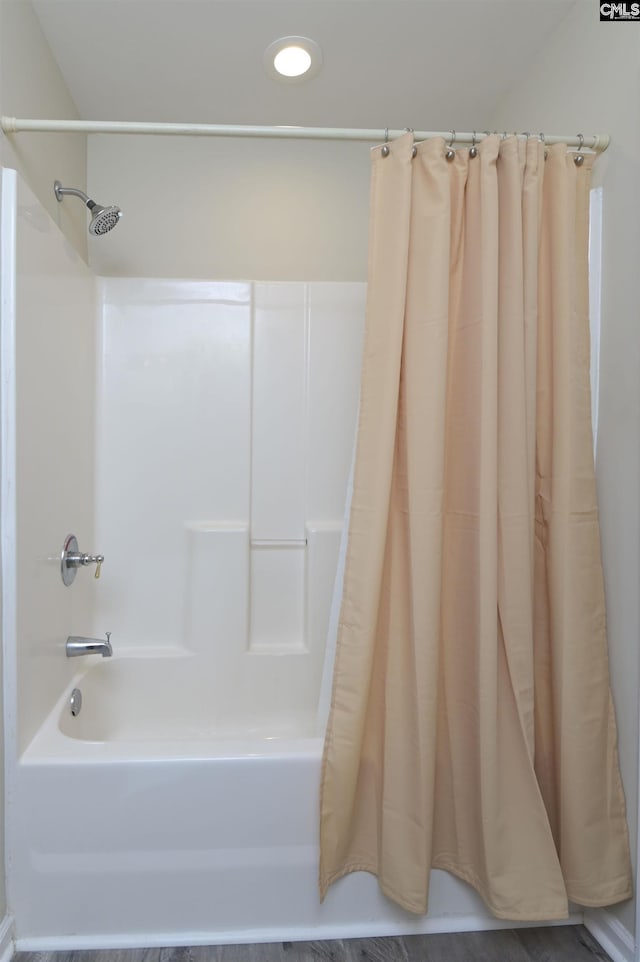 bathroom featuring shower / tub combo with curtain