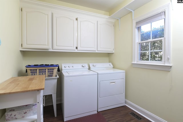 laundry area featuring cabinet space, visible vents, baseboards, dark wood-type flooring, and washing machine and clothes dryer