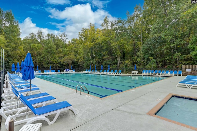 pool featuring a patio area and fence