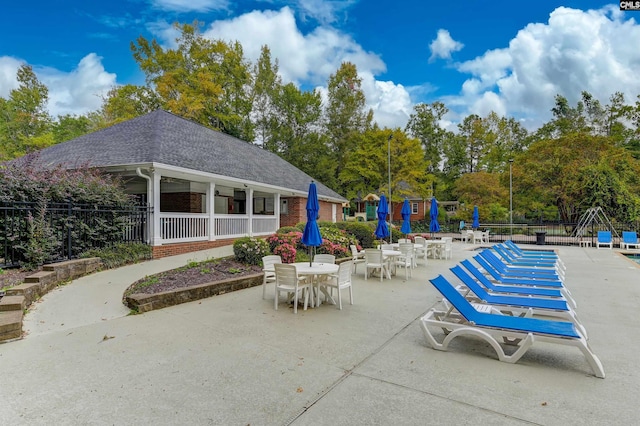 view of patio with outdoor dining space and fence