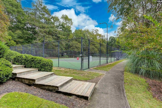 view of sport court featuring a gate and fence