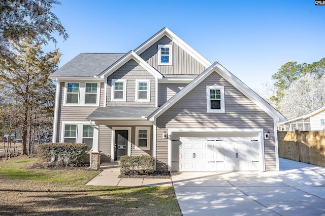 view of front of property featuring board and batten siding, concrete driveway, fence, and a garage