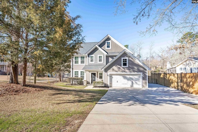 view of front of house with driveway, a front yard, and fence