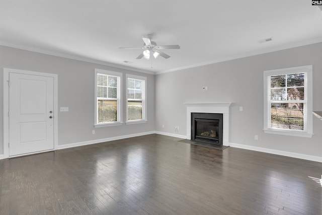 unfurnished living room with ornamental molding, dark wood-style flooring, and plenty of natural light