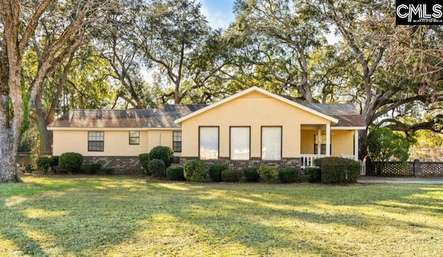 back of property featuring a yard, brick siding, and stucco siding