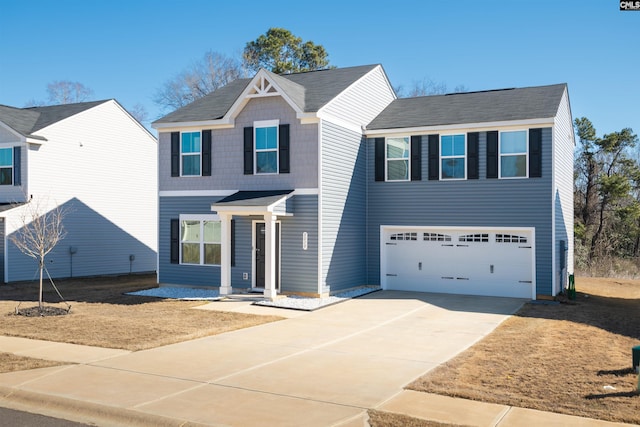 traditional-style home featuring driveway and an attached garage