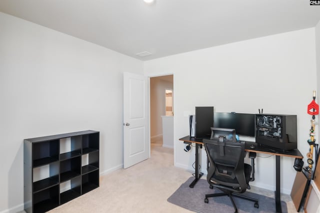 carpeted home office with baseboards