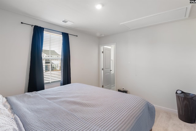 bedroom featuring attic access, light colored carpet, visible vents, and baseboards