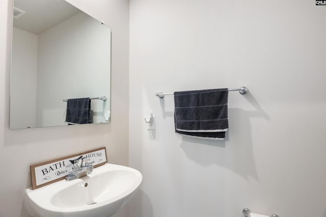 bathroom with visible vents and a sink