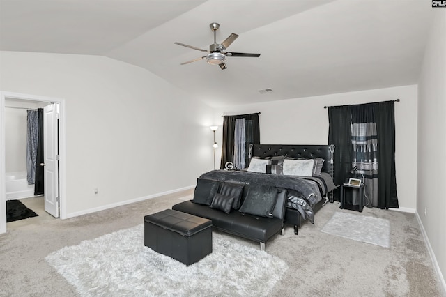 carpeted bedroom featuring visible vents, ensuite bathroom, baseboards, lofted ceiling, and ceiling fan