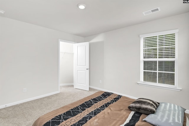 carpeted bedroom with baseboards and visible vents