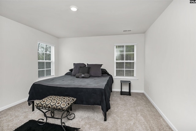 bedroom with baseboards, visible vents, and carpet floors