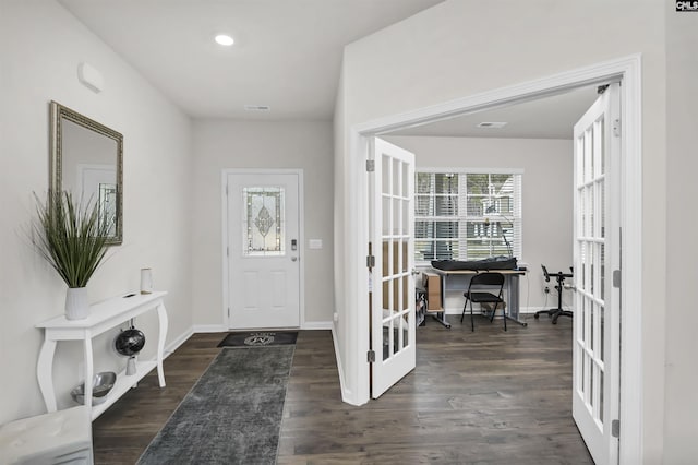 foyer featuring dark wood-style floors, french doors, and baseboards