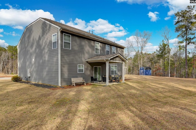 back of house with a yard and a patio area