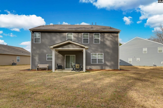 rear view of property with a yard, cooling unit, and a patio area