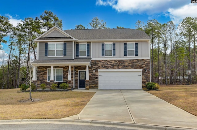 craftsman-style home with an attached garage, concrete driveway, a front yard, and board and batten siding