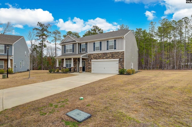 view of front of house featuring stone siding, driveway, an attached garage, and a front lawn