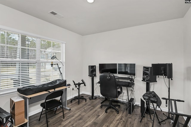 office space featuring visible vents, baseboards, and wood finished floors