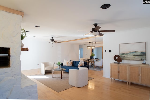 living area with ceiling fan and light wood-style flooring