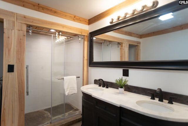 full bathroom featuring double vanity, a shower stall, and a sink