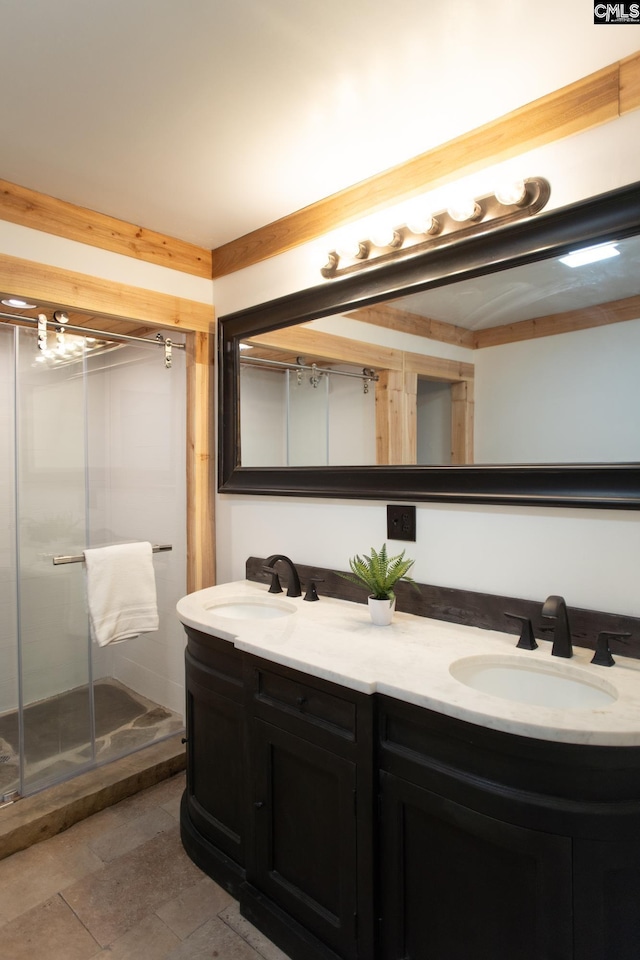 bathroom featuring double vanity, a sink, and a shower stall