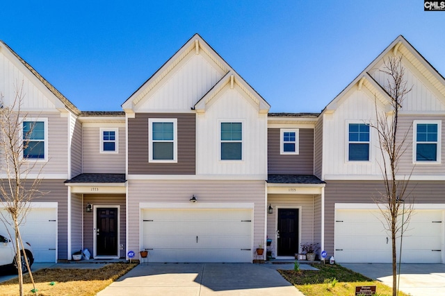 townhome / multi-family property featuring board and batten siding, driveway, and a garage