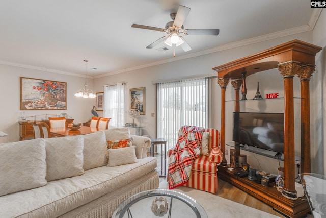 living area with visible vents, crown molding, and ceiling fan with notable chandelier