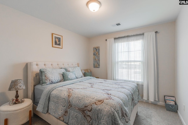 bedroom with carpet floors, visible vents, and baseboards