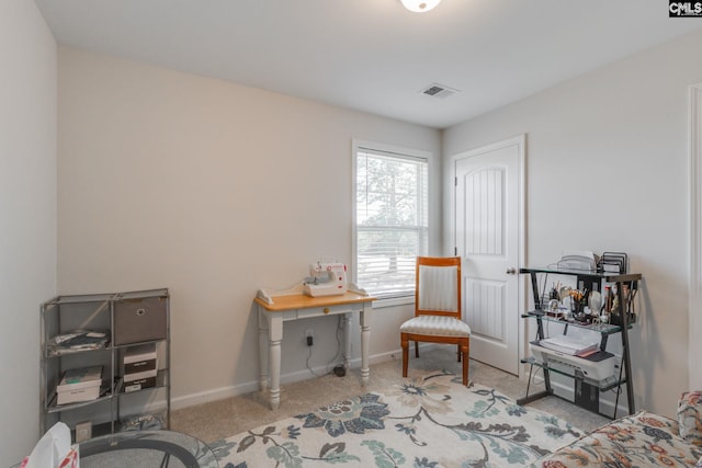 living area featuring carpet, visible vents, and baseboards