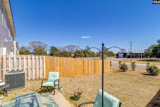 view of yard with cooling unit and fence