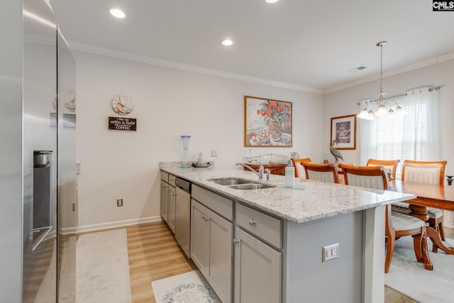 kitchen with appliances with stainless steel finishes, ornamental molding, a peninsula, gray cabinetry, and a sink