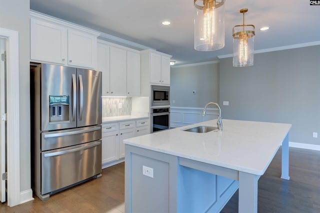 kitchen with stainless steel appliances, a sink, white cabinets, and crown molding