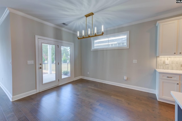 unfurnished dining area with baseboards, visible vents, dark wood-type flooring, and crown molding