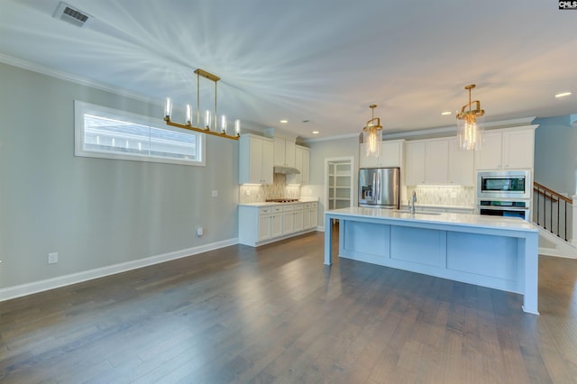 kitchen featuring light countertops, visible vents, appliances with stainless steel finishes, white cabinetry, and a sink